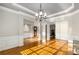 Formal dining room features hardwood floors, chandelier, and decorative columns at 895 Ovalene Sw Ln, Marietta, GA 30064