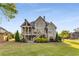 Rear exterior view of a home with multiple decks and a lush, green lawn at 895 Ovalene Sw Ln, Marietta, GA 30064