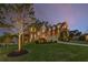 Exterior dusk shot of a brick and stone home with beautiful lawn and landscaping features at 895 Ovalene Sw Ln, Marietta, GA 30064