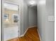 Hallway featuring hardwood floors and neutral walls, creating a simple and functional transition space at 895 Ovalene Sw Ln, Marietta, GA 30064