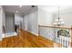 A beautiful hallway with hardwood floors and a decorative wrought iron railing leads to other rooms at 895 Ovalene Sw Ln, Marietta, GA 30064