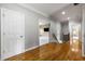 A beautifully lit hallway with neutral paint, and hardwood flooring at 895 Ovalene Sw Ln, Marietta, GA 30064