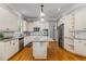 Bright kitchen features stainless appliances, granite counters, hardwood floors, and a center island at 895 Ovalene Sw Ln, Marietta, GA 30064