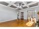 Living room with tray ceiling, hardwood flooring, display case and archway at 895 Ovalene Sw Ln, Marietta, GA 30064