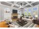 Inviting living room boasts a stone fireplace, coffered ceilings, and built-in bookshelves at 895 Ovalene Sw Ln, Marietta, GA 30064