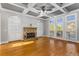 Living room featuring a stone fireplace, built-in shelving, and coffered ceilings at 895 Ovalene Sw Ln, Marietta, GA 30064