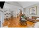 Spacious living room with wood floors, fireplace, and view to the kitchen at 895 Ovalene Sw Ln, Marietta, GA 30064