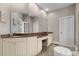 Bathroom with dual sinks, granite counters, and vanity area at 895 Ovalene Sw Ln, Marietta, GA 30064
