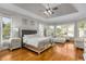 Spacious main bedroom with hardwood floors, tray ceilings, and multiple windows for natural light at 895 Ovalene Sw Ln, Marietta, GA 30064