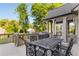 Outdoor patio with a dining set, grill, and views of the surrounding yard and trees at 895 Ovalene Sw Ln, Marietta, GA 30064