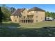 Expansive backyard view featuring a two-story deck and patio perfect for outdoor living at 1081 Humphries Nw Rd, Conyers, GA 30012