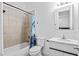 Well-lit bathroom with a bathtub/shower combination, white vanity, and stylish mirror at 1081 Humphries Nw Rd, Conyers, GA 30012