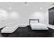 Minimalist bedroom with white sectional sofa, sleek bed frame, and neutral tones at 1081 Humphries Nw Rd, Conyers, GA 30012