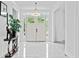 Bright foyer with elegant lighting, contemporary decor, and white tile flooring at 1081 Humphries Nw Rd, Conyers, GA 30012