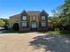 Stately two-story home boasts a circular driveway and manicured lawn at 1081 Humphries Nw Rd, Conyers, GA 30012