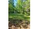 Expansive backyard featuring a storage shed and mature trees, offering privacy at 4775 Ben Hill Rd, Douglasville, GA 30134