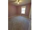 Simple bedroom featuring carpet and window at 4775 Ben Hill Rd, Douglasville, GA 30134