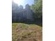 A side view of the house showing the chimney and a small, covered patio at 4775 Ben Hill Rd, Douglasville, GA 30134