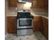Well-lit kitchen with stainless steel appliances and wooden cabinets at 4775 Ben Hill Rd, Douglasville, GA 30134