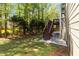 Backyard view featuring a wood staircase, landscaping, grassy area, and the home's exterior at 617 Wexford Ct, Acworth, GA 30102