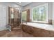 Elegant bathroom with separate shower and tub, and tile surround at 617 Wexford Ct, Acworth, GA 30102
