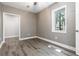 Bedroom with LVP floors and natural light streaming through the windows at 617 Wexford Ct, Acworth, GA 30102