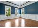 Dining room with hardwood floors, wainscoting, and elegant chandelier at 617 Wexford Ct, Acworth, GA 30102
