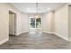 Bright dining room with LVP floors, elegant light fixture, and large window at 617 Wexford Ct, Acworth, GA 30102