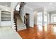 Grand foyer showcasing hardwood floors, staircase, and arched doorways leading into other rooms at 617 Wexford Ct, Acworth, GA 30102