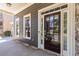 View of the front porch with a stained wood door, sidelights, and stone accents at 617 Wexford Ct, Acworth, GA 30102