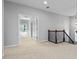 Upper hallway with a view into a room featuring a treed view and an ornate dark-stained railing at 617 Wexford Ct, Acworth, GA 30102