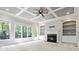 Spacious living room featuring a fireplace, built-in bookshelves, and large windows overlooking a treed backyard at 617 Wexford Ct, Acworth, GA 30102