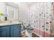 Quaint bathroom with a vanity, commode, shower, and decorative shower curtain at 782 Ridgeland Trl, Clarkston, GA 30021