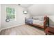 Cozy bedroom features wood-look laminate flooring and a window offering natural light and views of the surroundings at 782 Ridgeland Trl, Clarkston, GA 30021
