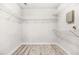 Large walk-in closet with open shelving, offering ample storage and organization, paired with wood-look floors at 782 Ridgeland Trl, Clarkston, GA 30021