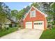 Attractive brick home featuring a two-car garage, a well-maintained lawn, and mature trees at 782 Ridgeland Trl, Clarkston, GA 30021