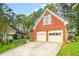 Attractive brick home featuring a two-car garage, a well-maintained lawn, and mature trees at 782 Ridgeland Trl, Clarkston, GA 30021