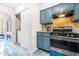 Kitchen featuring painted cabinets, stainless steel oven, and convenient laundry access at 782 Ridgeland Trl, Clarkston, GA 30021