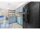 Well-lit kitchen with granite countertops, light-blue cabinetry, and black appliances at 782 Ridgeland Trl, Clarkston, GA 30021