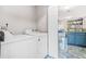 Efficient laundry area with modern appliances, located off of the open concept kitchen, for convenience at 782 Ridgeland Trl, Clarkston, GA 30021