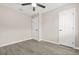A cozy bedroom featuring a ceiling fan and neutral walls, complemented by wood-look flooring at 1158 Crystal Lake Rd, Atlanta, GA 30349