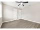 An inviting bedroom with two entryways, a ceiling fan, and modern wood-look flooring at 1158 Crystal Lake Rd, Atlanta, GA 30349
