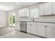 Bright kitchen with stainless appliances, white cabinets, and views of the backyard through French doors at 1158 Crystal Lake Rd, Atlanta, GA 30349