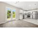 Modern kitchen with stainless steel appliances, white cabinets, and views of the outdoor patio at 1158 Crystal Lake Rd, Atlanta, GA 30349
