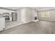 Open-concept living area featuring wood floors and a fireplace flowing into a modern kitchen at 1158 Crystal Lake Rd, Atlanta, GA 30349