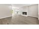 Inviting living room with modern flooring, cozy fireplace, and a seamless flow into the kitchen at 1158 Crystal Lake Rd, Atlanta, GA 30349