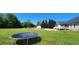 Expansive backyard featuring a trampoline, in-ground pool, outbuilding, patio and lush green grass at 116 Ridge Xing, Temple, GA 30179