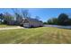View of the attached garage and large fenced yard of this lovely home at 116 Ridge Xing, Temple, GA 30179