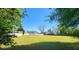 Large backyard area with green grass and a shed, perfect for outdoor activities at 116 Ridge Xing, Temple, GA 30179