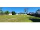 Spacious backyard with a shed, wooden fence, and lush green grass on a sunny day at 116 Ridge Xing, Temple, GA 30179